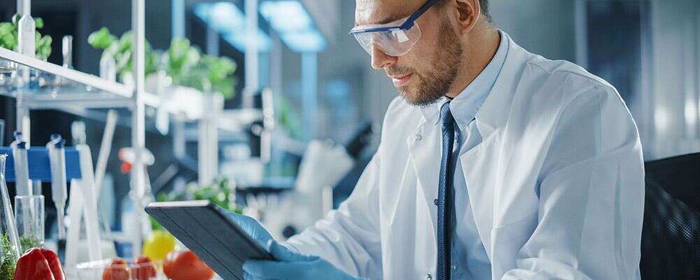 a technical office watching something on tablet in testing lab